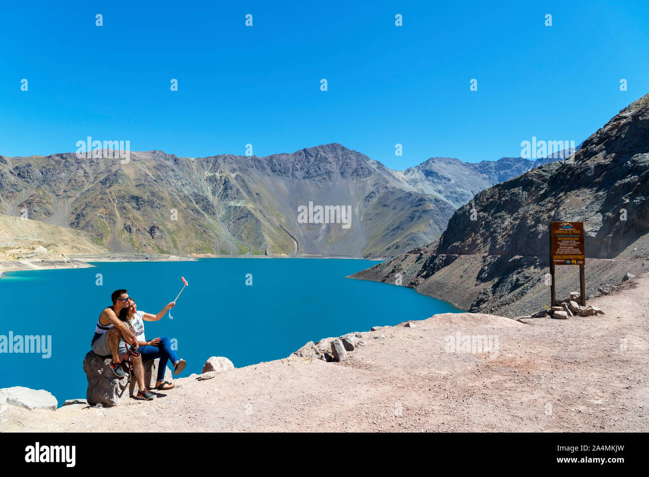 Chile, Andes Mountains. Young couple taking a selfie with a selfie stick at the Embalse el Yeso (El Yeso Dam), Andes Mountains, Chile, South America Stock Photo