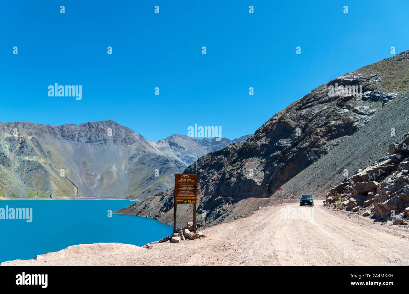 Chile, Andes Mountains. Car driving on the road alongside the Embalse el Yeso (El Yeso Dam), Andes Mountains, Santiago Metropolitan Region, Chile, Sou Stock Photo