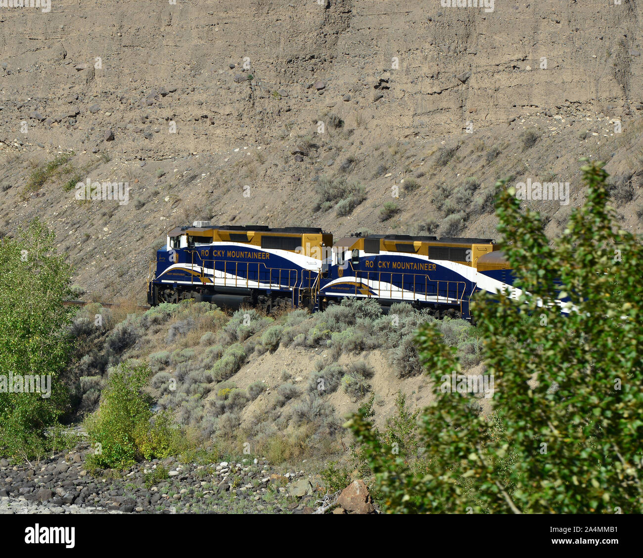 Rocky Mountaineer on its way from Kamloops to Vancouver travelling alongside Thompson River. Stock Photo