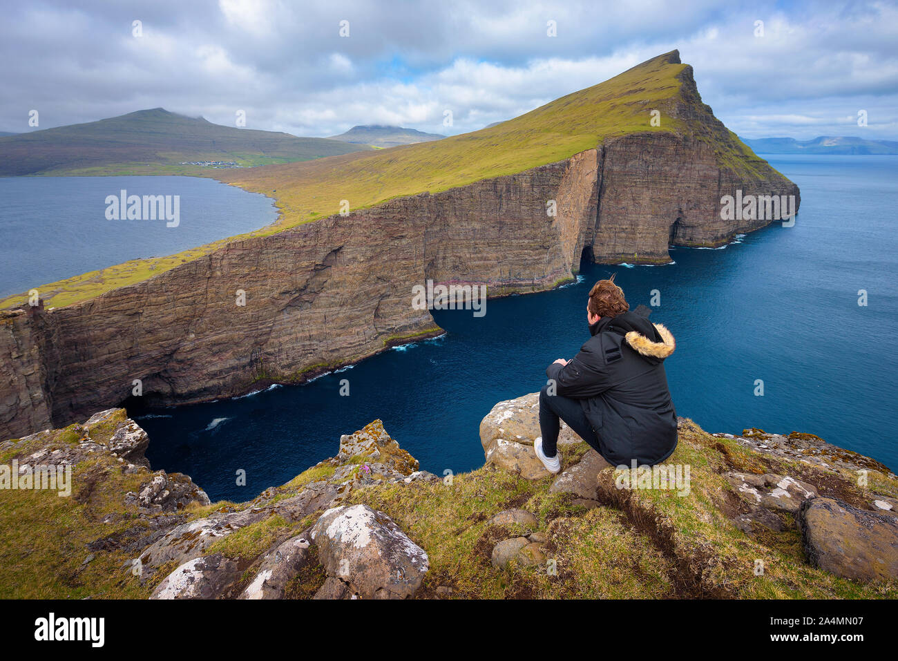Hiker looking at the lake Sorvagsvatn on Faroe Islands Stock Photo