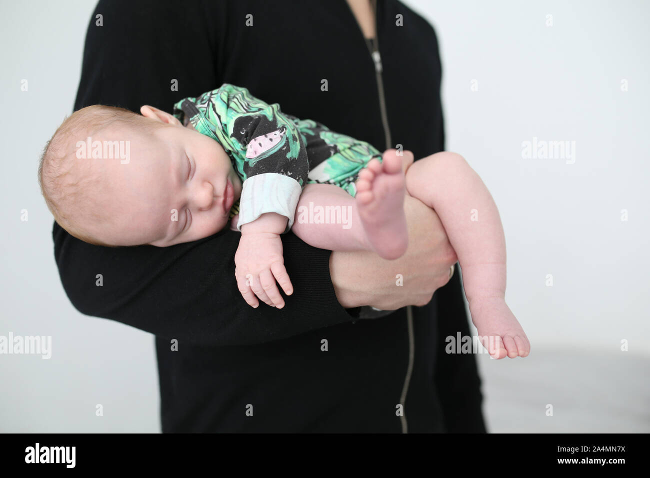 Baby sleeping on fathers arm Stock Photo Alamy
