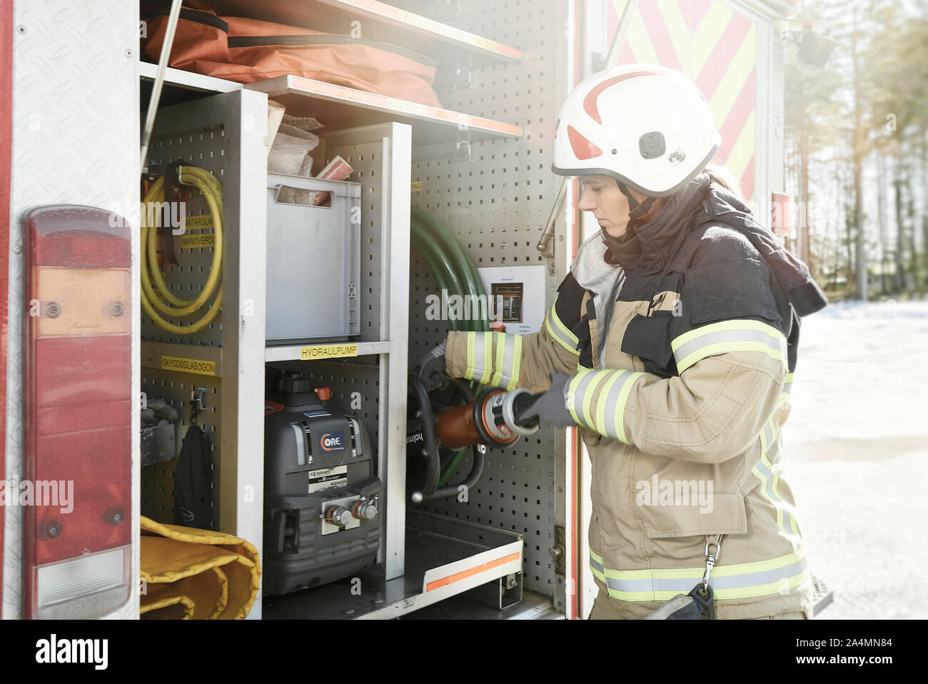 Firefighter near fire engine Stock Photo