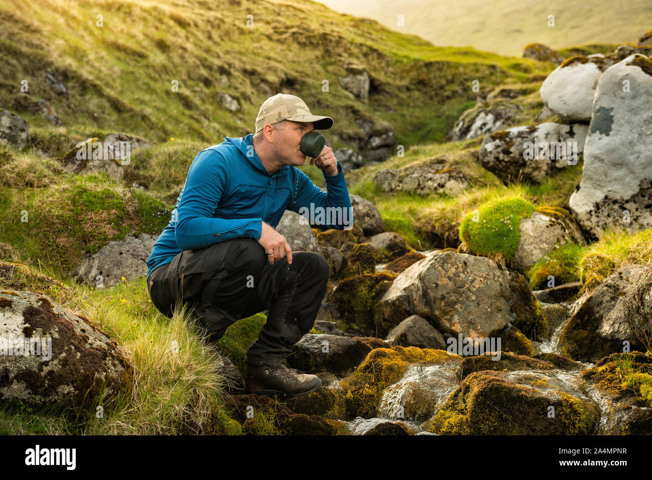 Hiker drinking water Stock Photo
