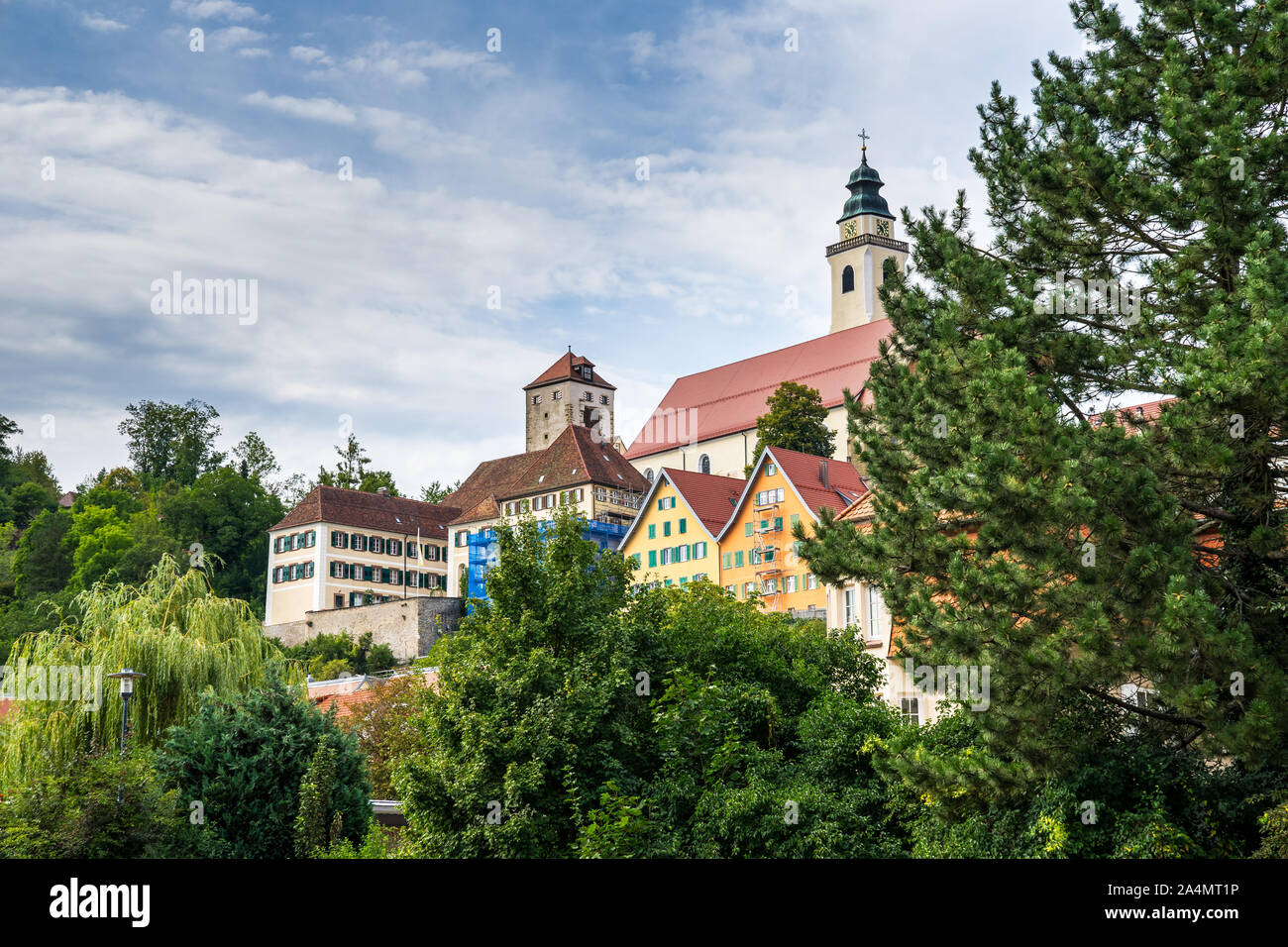 Germany, Old town houses of black forest village horb am neckar surrounded by green trees on sunny day Stock Photo