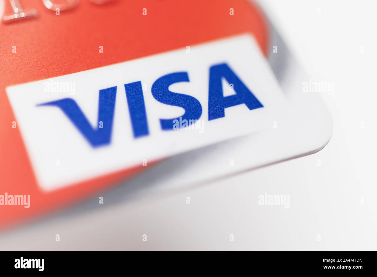 London / UK - October 9th 2019 - VISA logo on red bank card, closeup macro view with a shallow depth of field Stock Photo