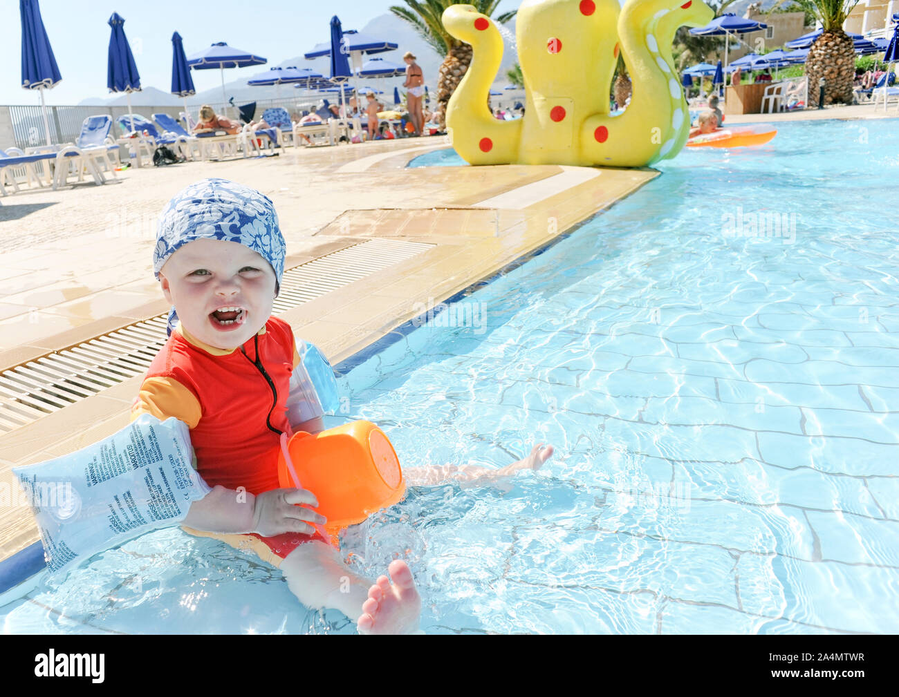 Baby girl in paddling pool Stock Photo Alamy