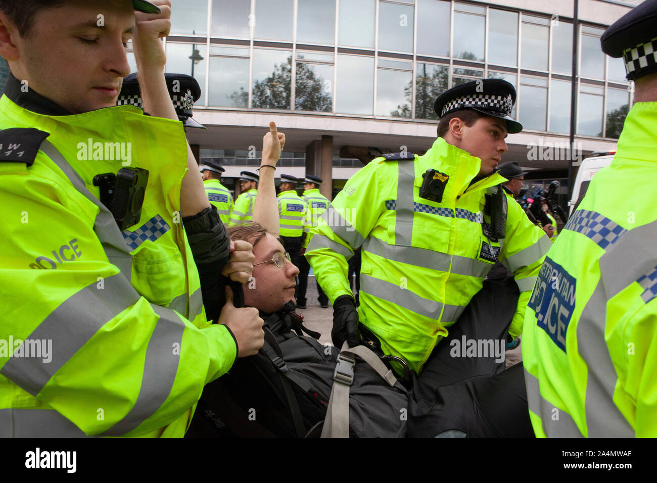 Police made mass arrests as Extinction Rebellion activists defied a London-wide ban on public protests this morning to close off Millbank outside the offices of MI5. Protesting about the lack of food security possible if climate change isn't averted, they parked a caravan in the road and staged a sit in with singing and picnics. Stock Photo