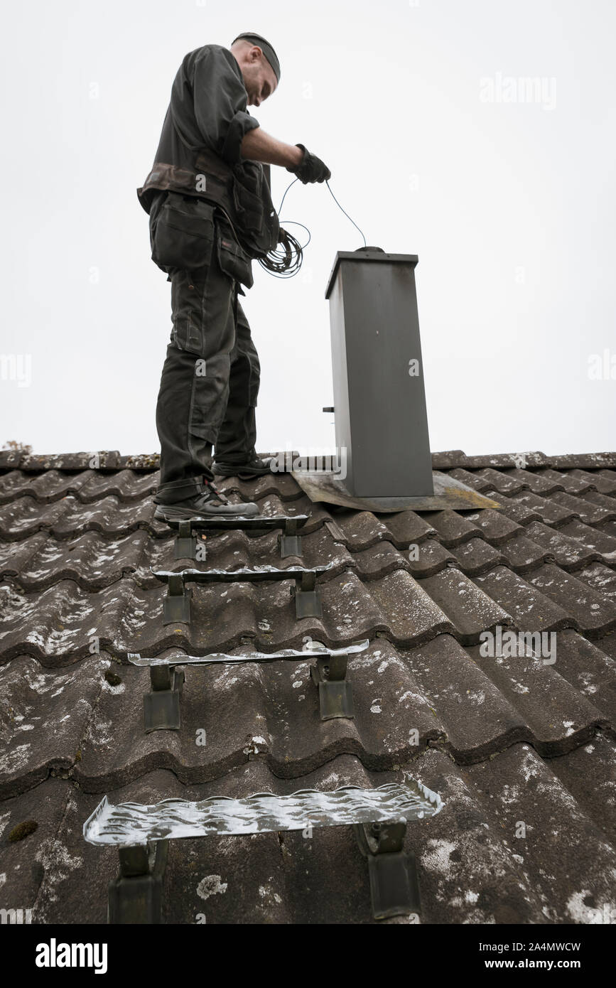 Chimney Sweep cleaning chimney Stock Photo