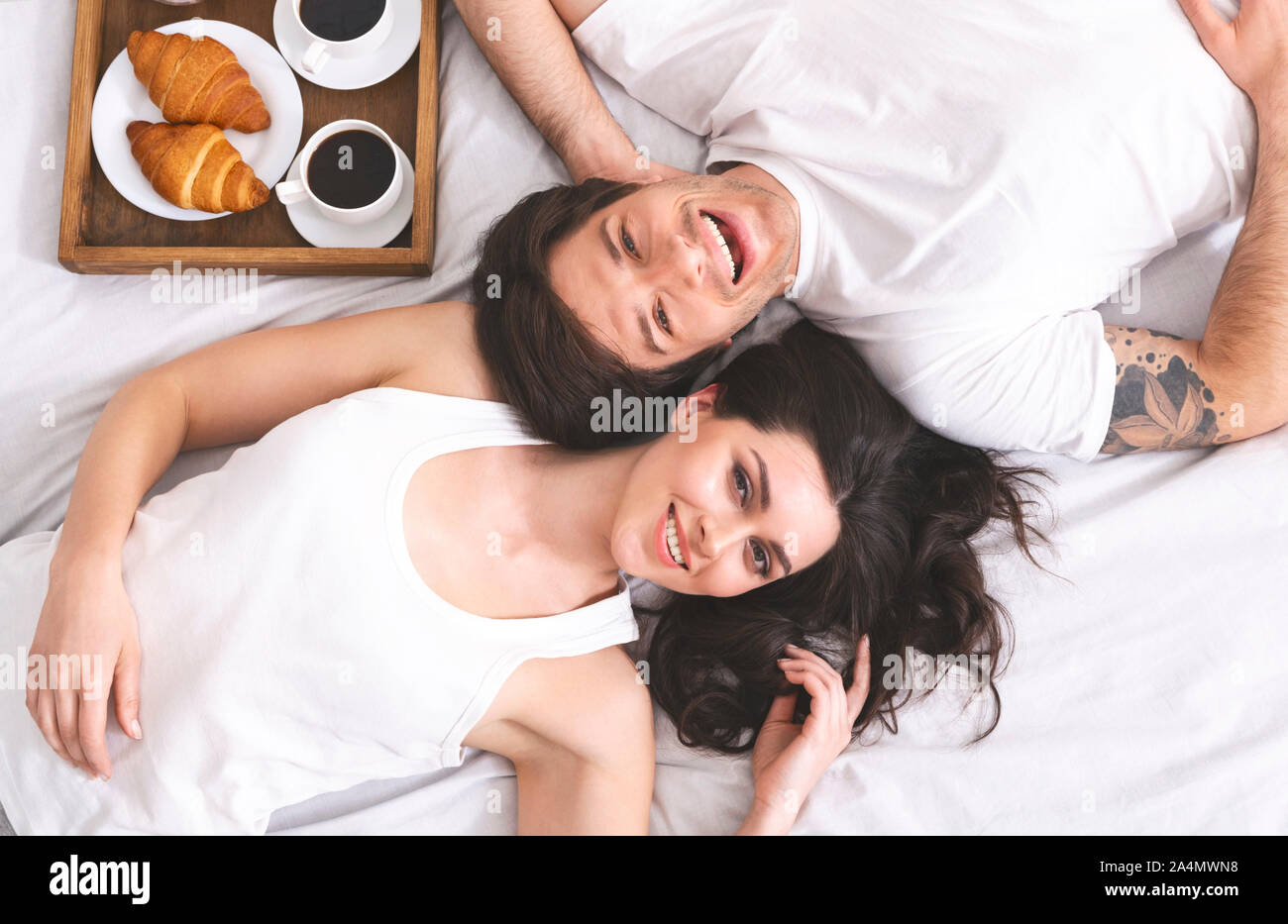 Young couple lying in bed hi-res stock photography and images - Alamy