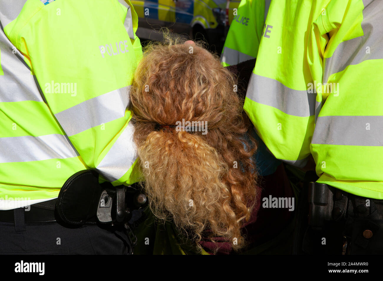 Police made mass arrests as Extinction Rebellion activists defied a London-wide ban on public protests this morning to close off Millbank outside the offices of MI5. Protesting about the lack of food security possible if climate change isn't averted, they parked a caravan in the road and staged a sit in with singing and picnics. Stock Photo