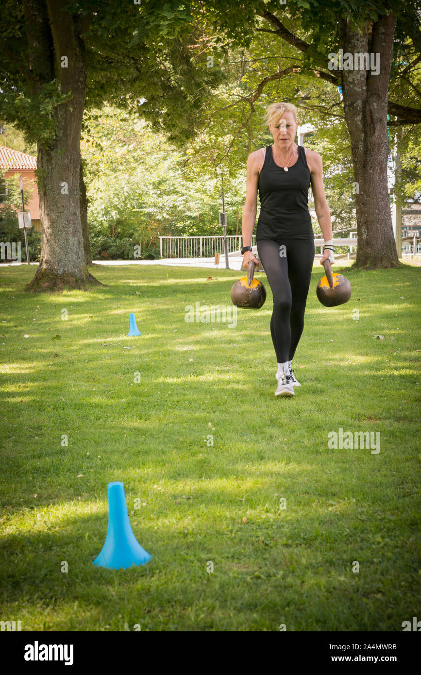 Woman carrying weights Stock Photo Alamy