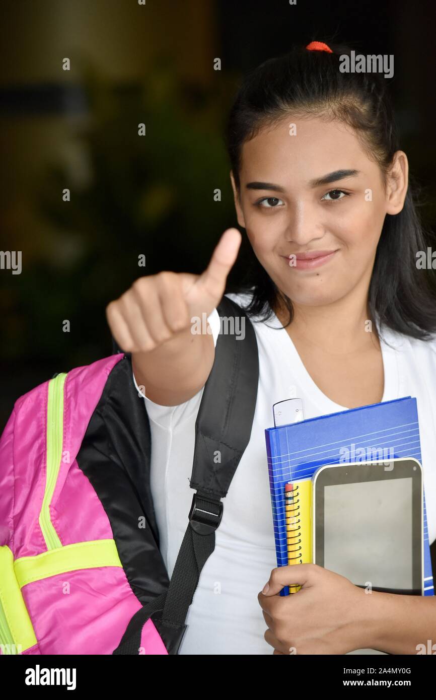 Cute Female Student With Thumbs Up With Notebooks Stock Photo - Alamy