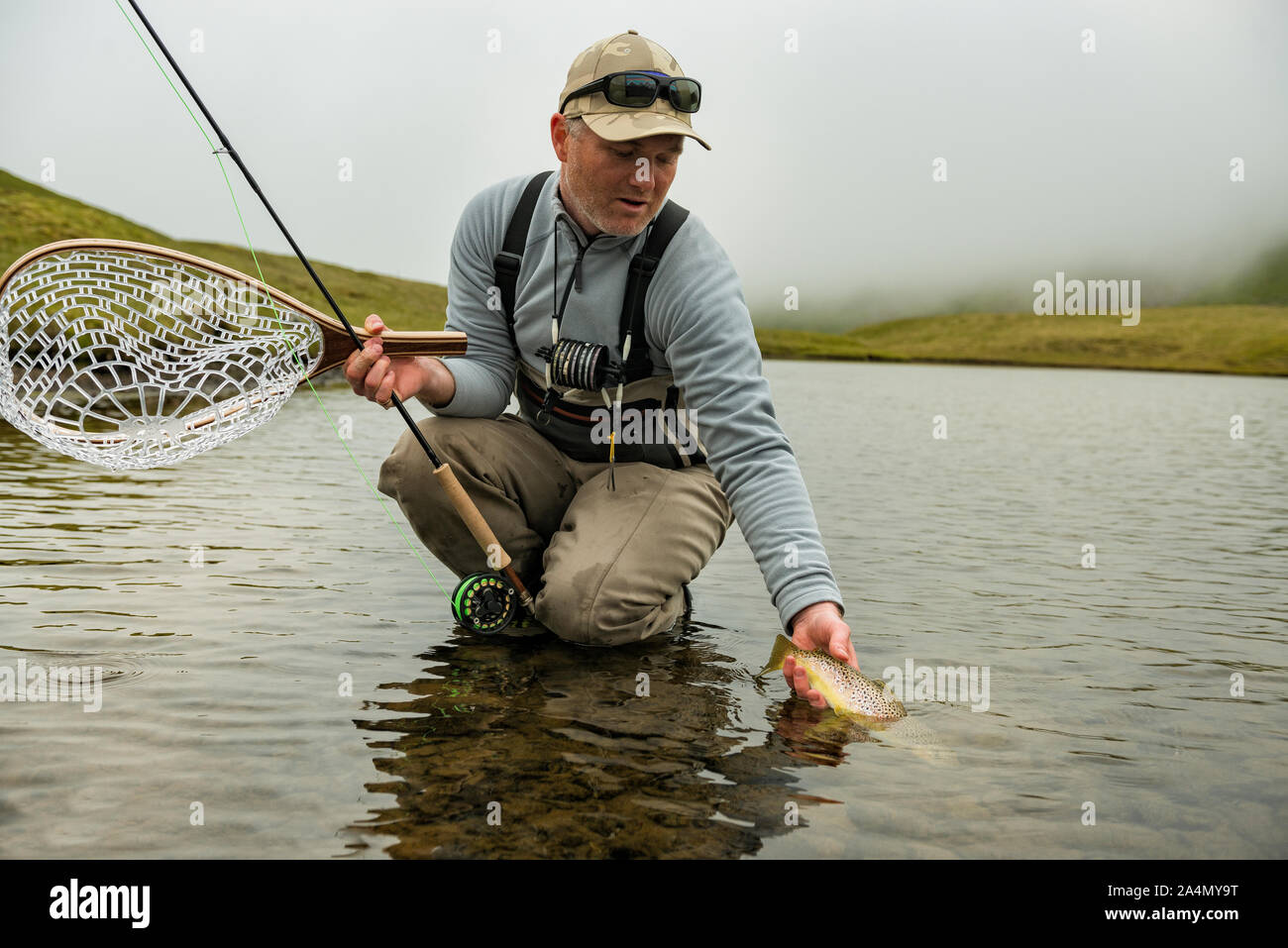 Fisherman with caught fish Stock Photo