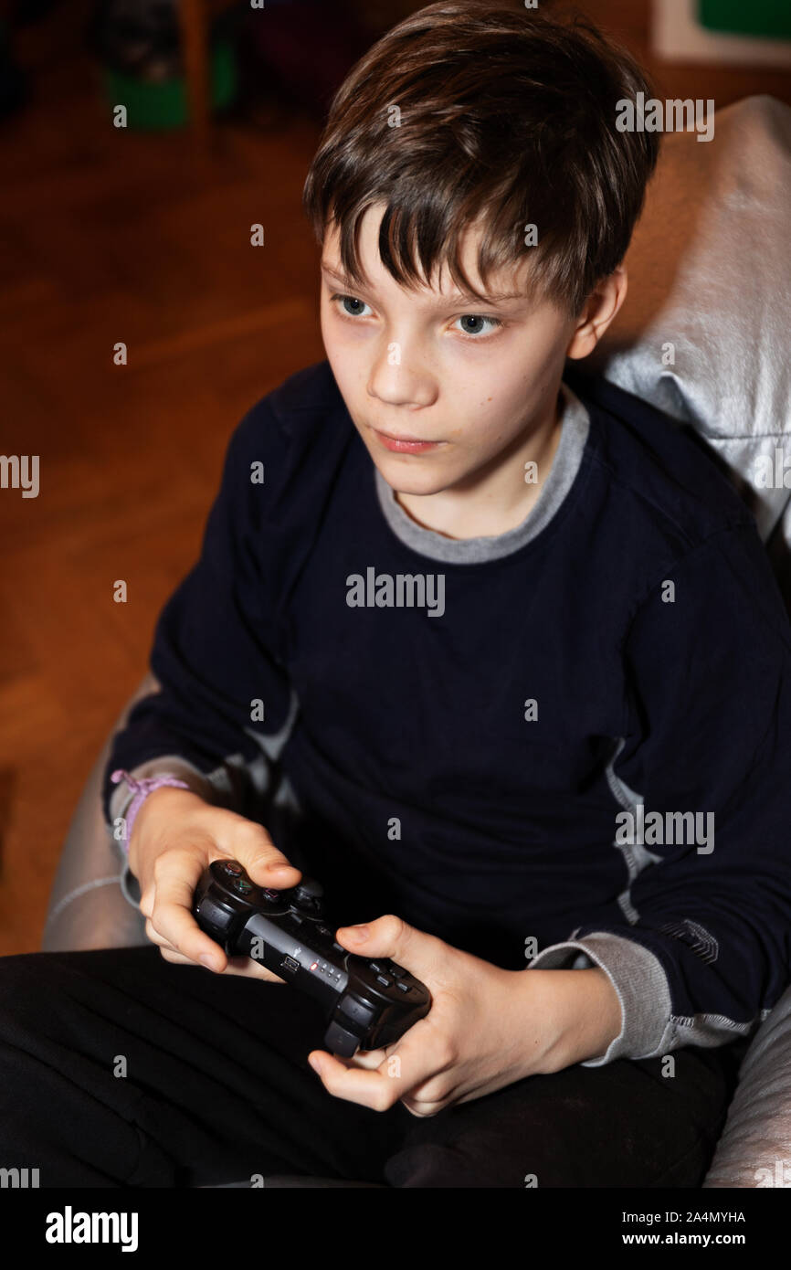 Boy playing video game Stock Photo