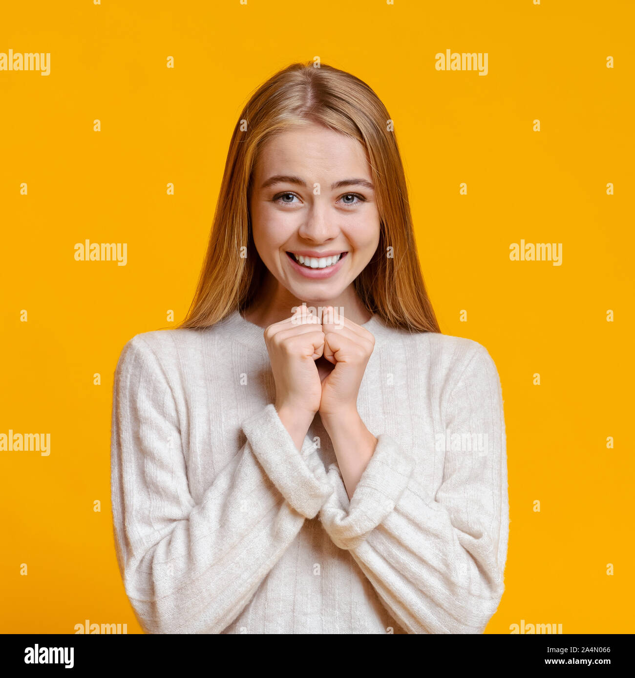 Excited Girl Pleading For Something And Keeping Hands Together Stock Photo