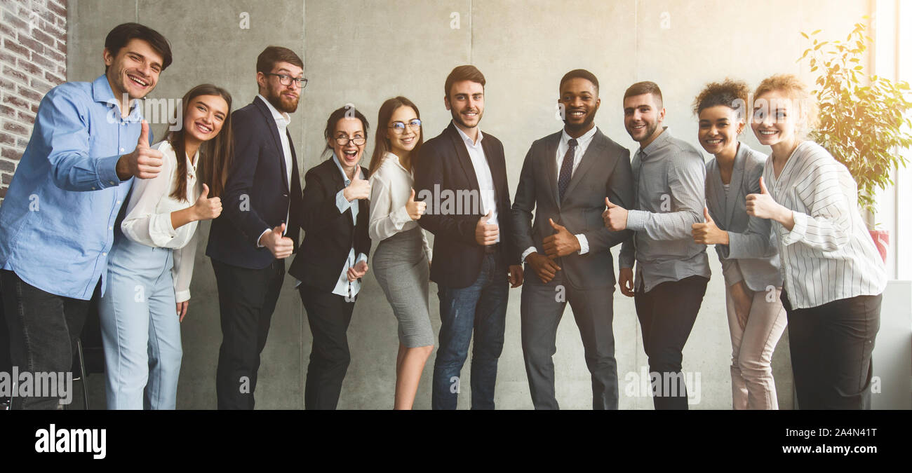 Happy diverse business team showing thumbs up Stock Photo - Alamy