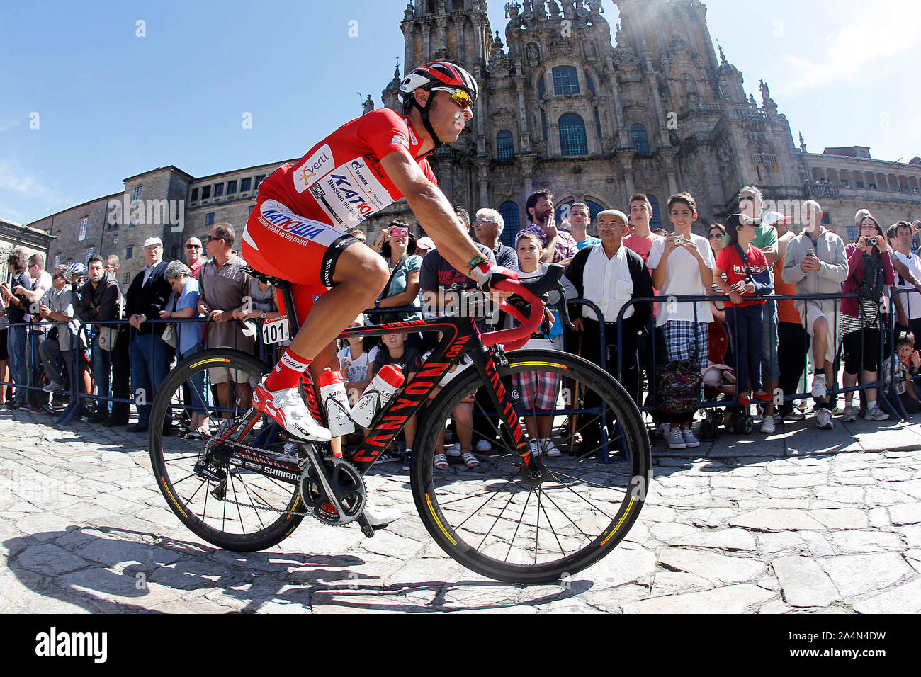 Joaquin Purito Rodriguez passes by the front of the Obradoiro of the Cathedral of Santiago de Compostela before the stage of La Vuelta 2012 between Sa Stock Photo