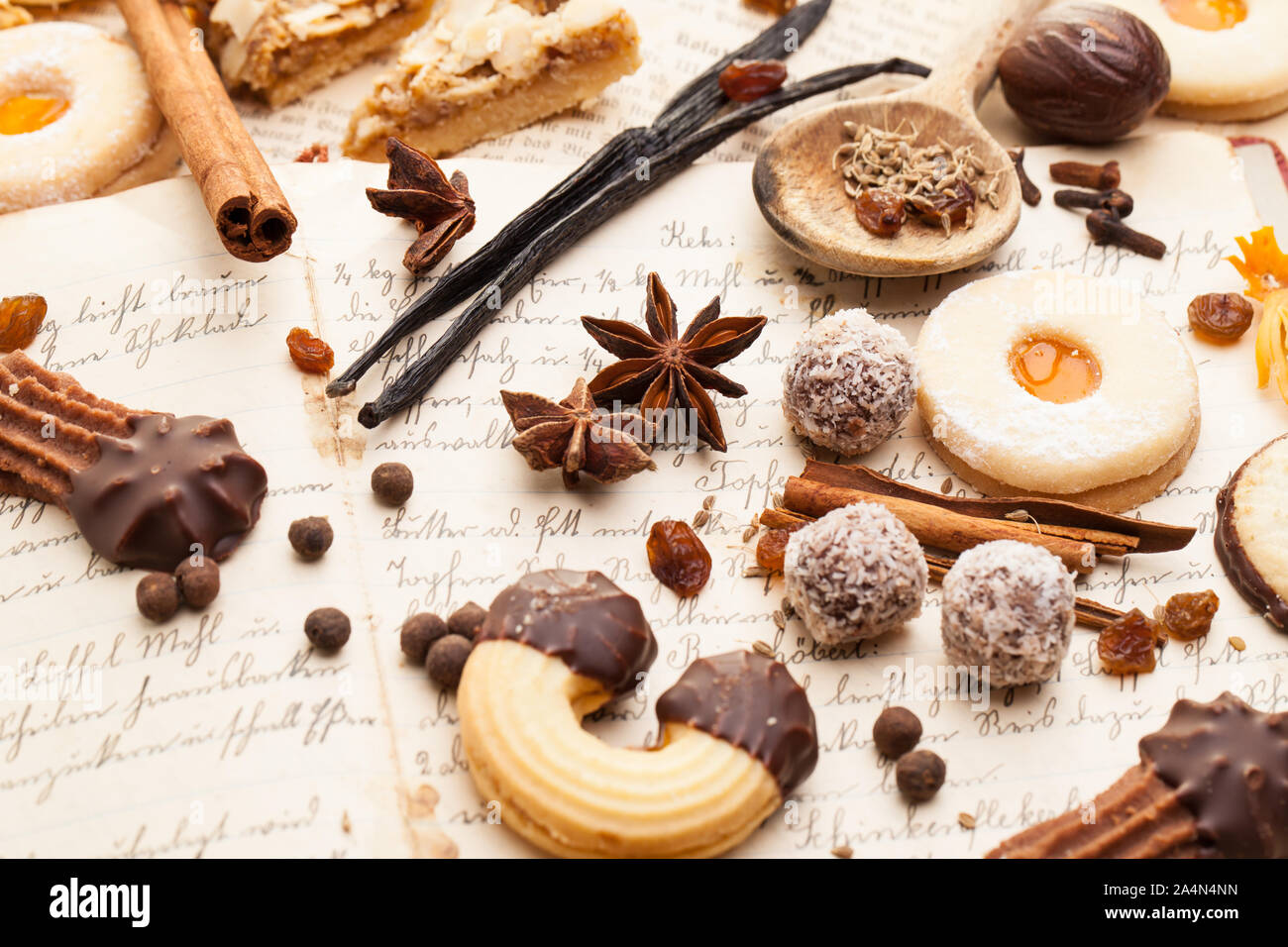 Biscuits and spices lying on a old cookbook Stock Photo