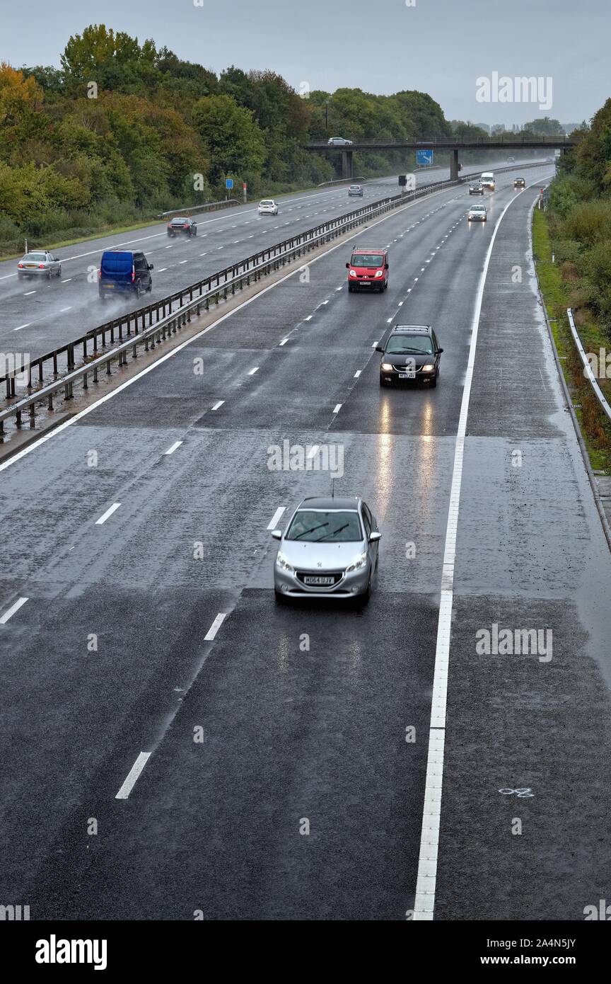 An elevated view of traffic the M3 Motorway near Shepperton on a dull and rainy day, Surrey England UK Stock Photo