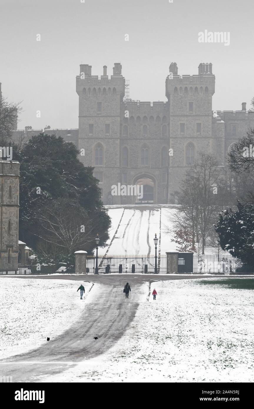 Windsor Castle covered in winter snow as seen from the Long Walk