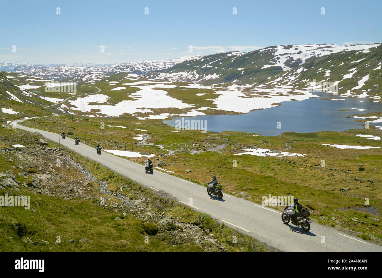 People on motorbikes in mountainous landscape Stock Photo