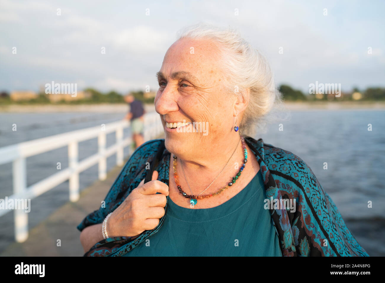 Senior woman smiling on pier Stock Photo