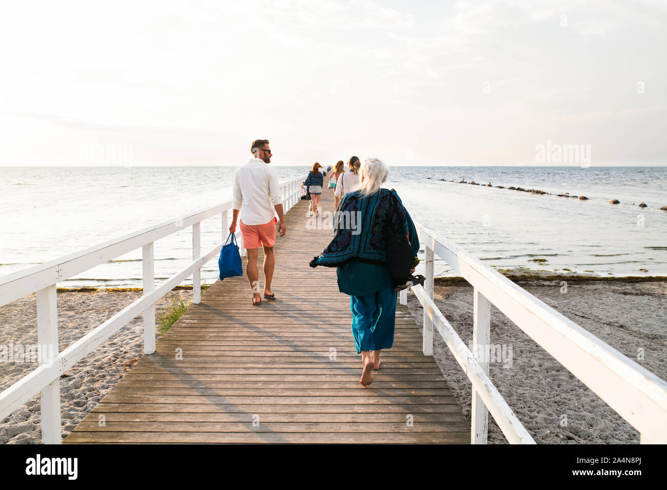 People walking on pier at seaside Stock Photo