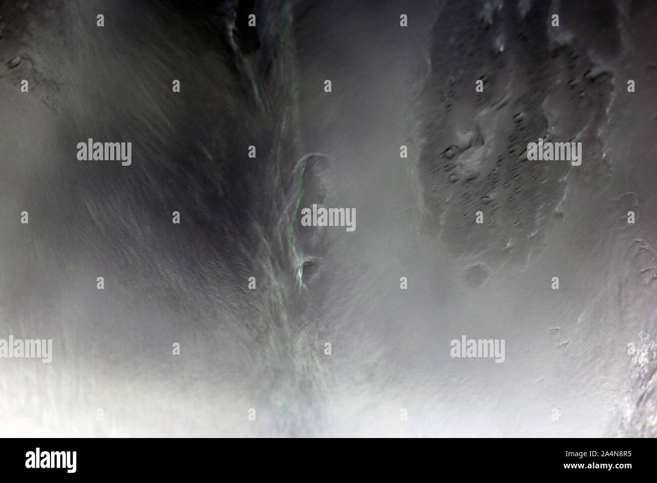 Inside a car washing machine - view to the wet window is abstract ...