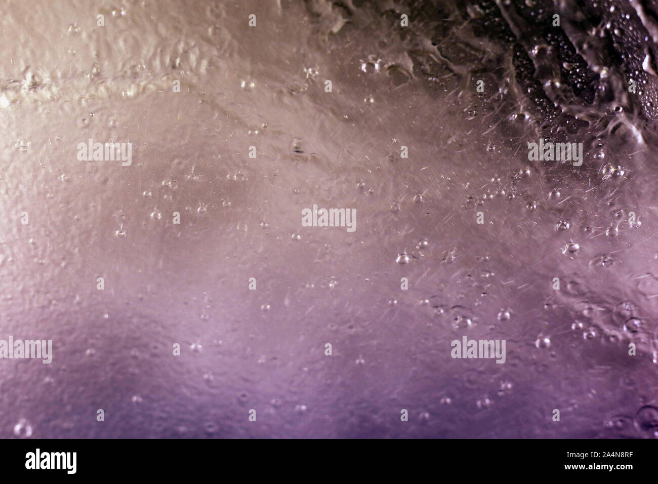 Inside a car washing machine - view to the wet window is abstract ...
