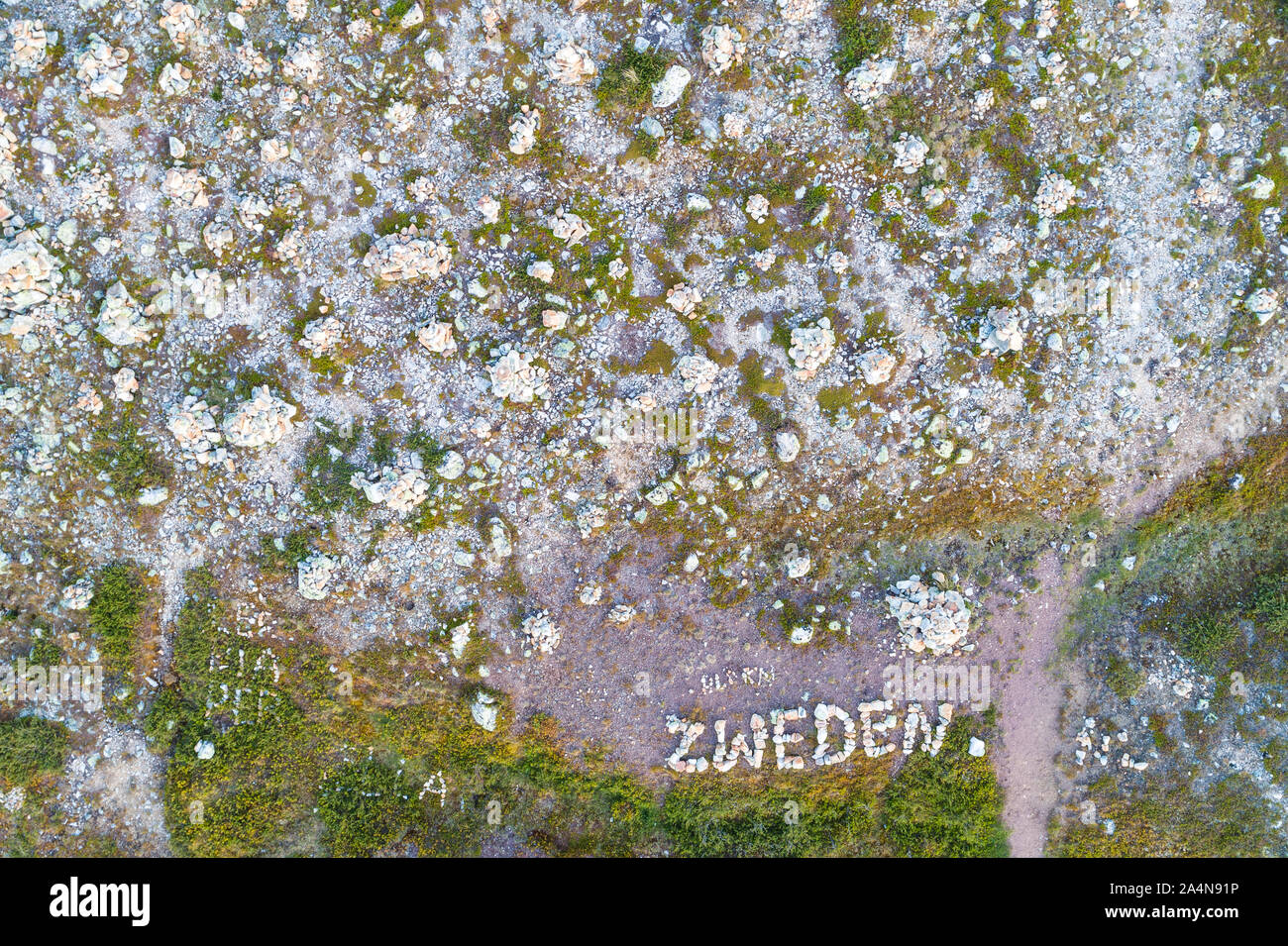 Sign made with rocks Stock Photo - Alamy