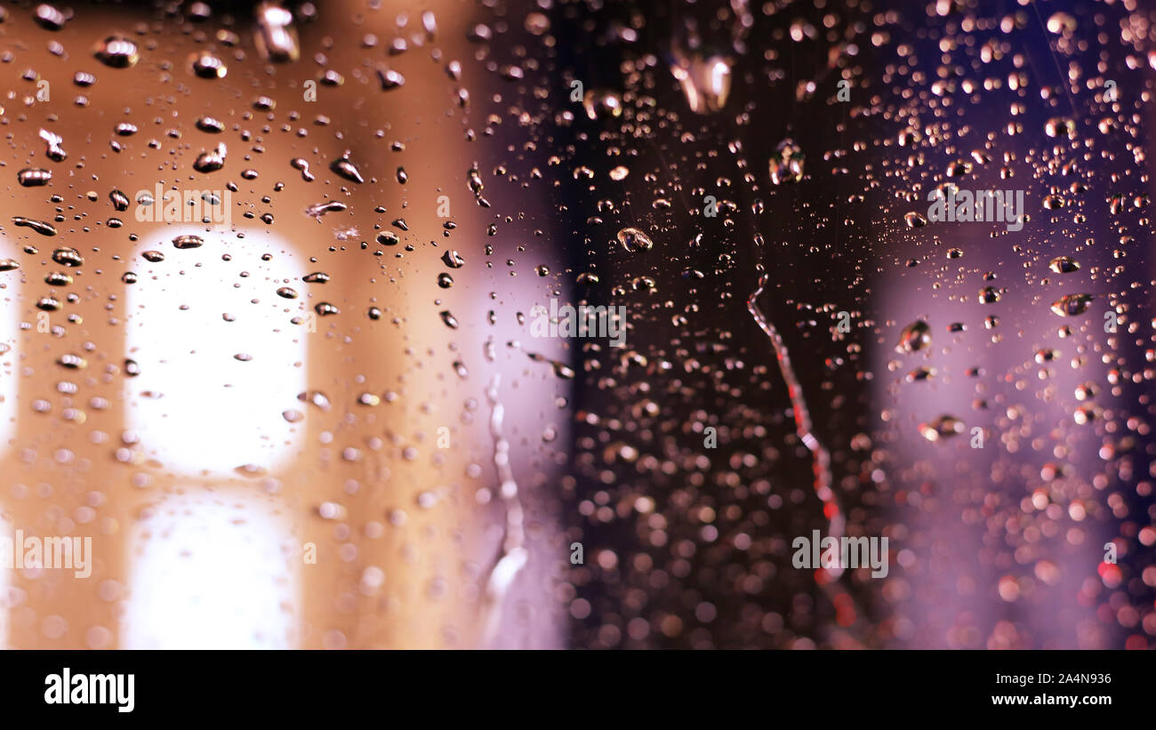 Inside a car washing machine - view to the wet window is abstract ...