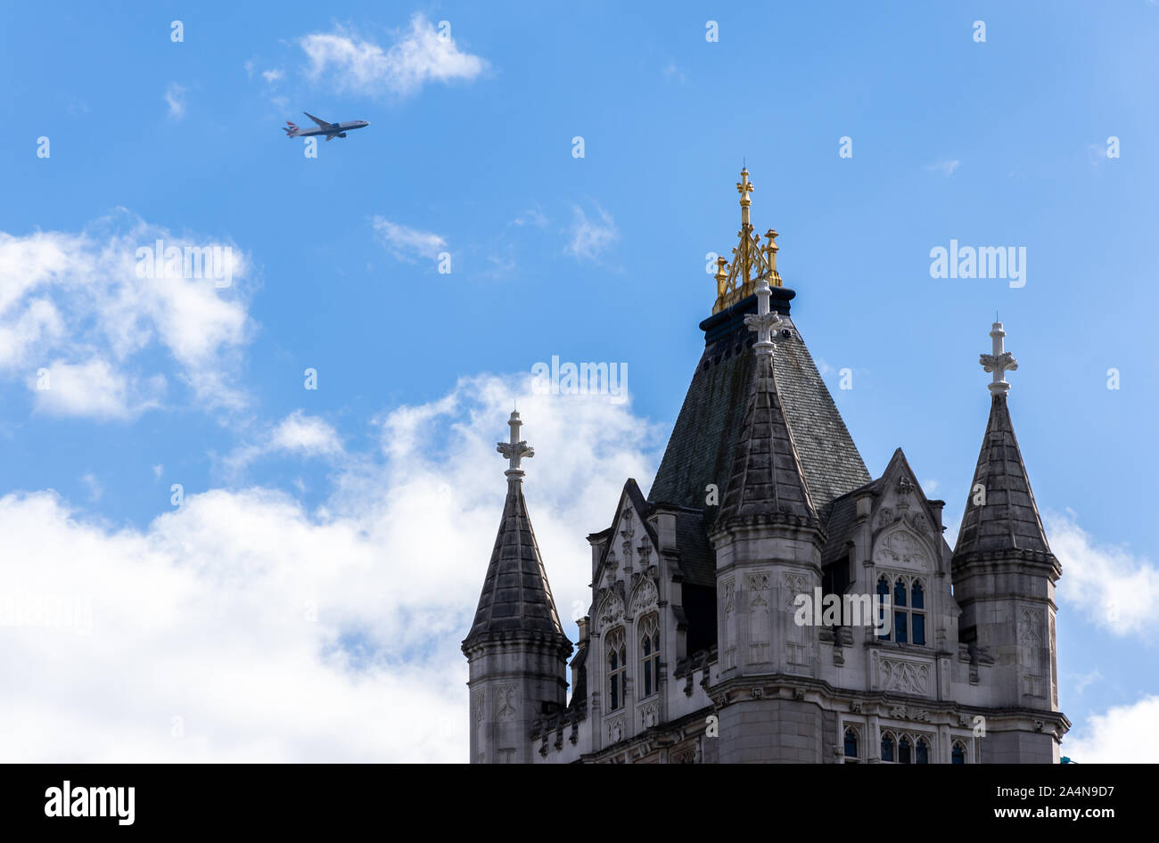 An airplane flying over the Tower Bridge of London,UK. Airplane low pass over London Stock Photo