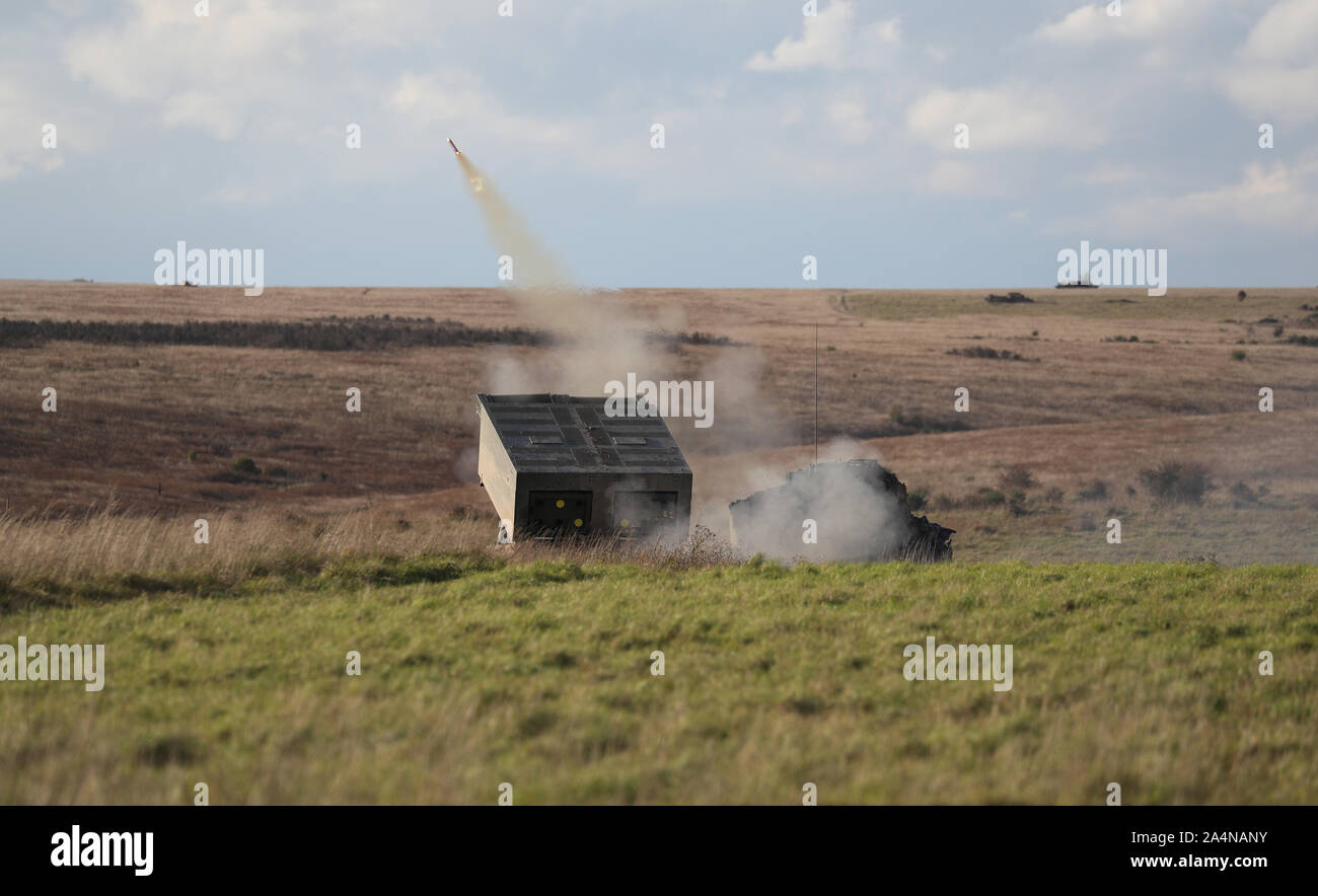Members of 26 Regiment Royal Artillery position their Multi Launch Rocket System (MLRS) on Salisbury Plain, Wiltshire during exercise Congreve Spear. Stock Photo