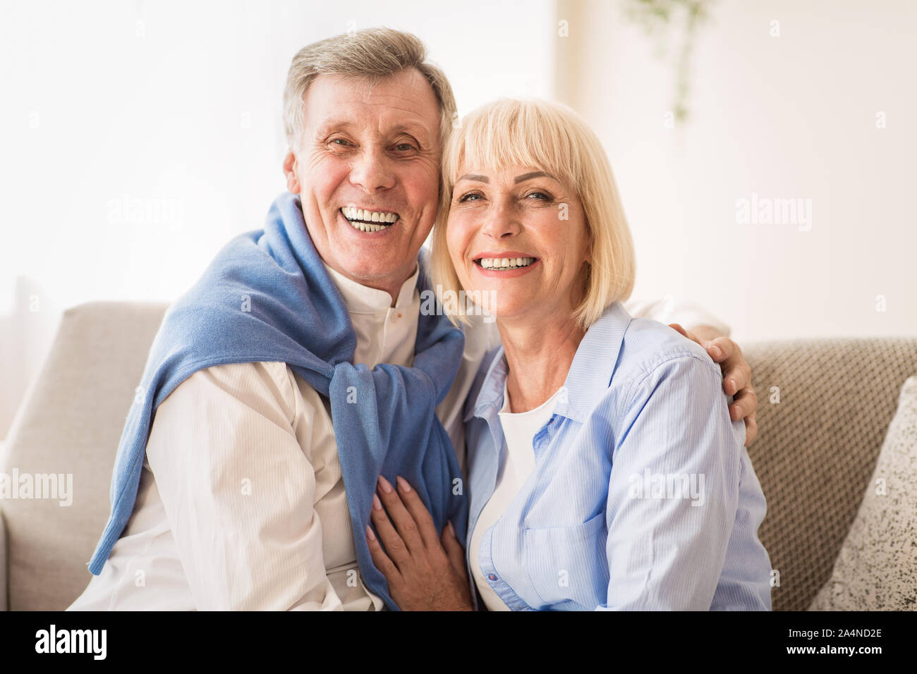 Loving senior couple smiling happily at camera Stock Photo