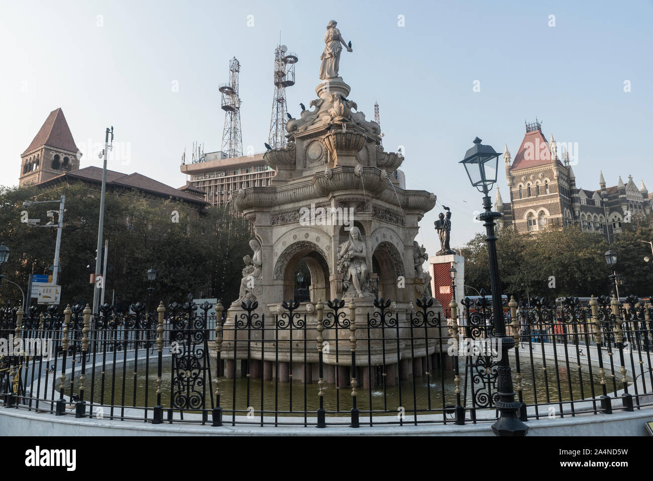 The British-era Flora fountain in fort area in Mumbai, India. It is an ornamentally and exquisitely sculpted architectural heritage monument located at the southern end of the historic Dadabhai Naoroji Road, (earlier called the Mile Long Road). It was built in CE 1864, and depicts the Roman goddess Flora. It was built at a total cost of Rs. 47,000, or 9000 pounds sterling. It was refurbished by Indian National Trust for Art and Culture Heritage (INTACH) and inaugurated in CE 2019 January, with restoration of the sculpture and water fountains, at a cost of Rs. 4.25 Crore. Stock Photo