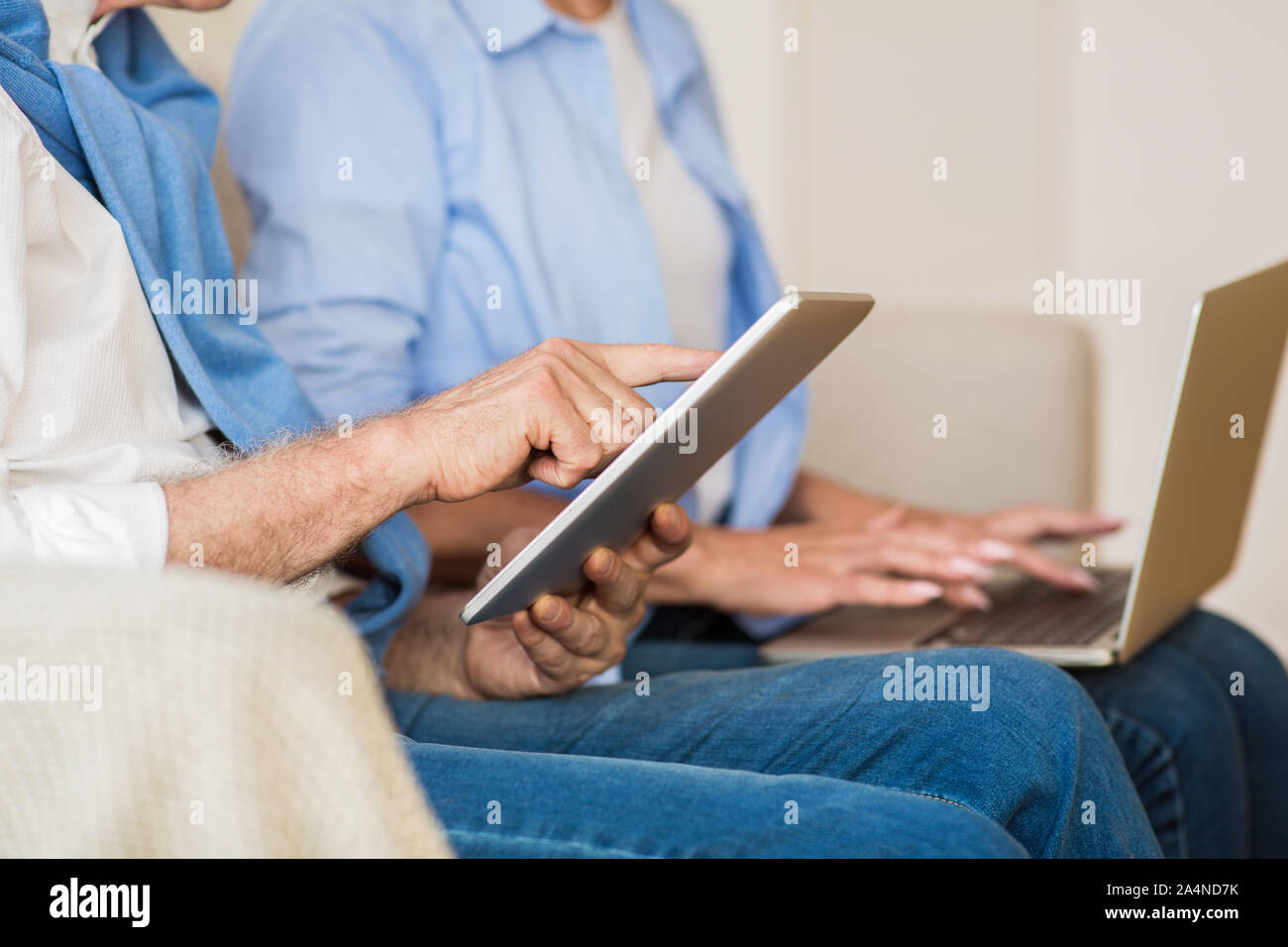 Modern mature couple using various gadgets, closeup Stock Photo