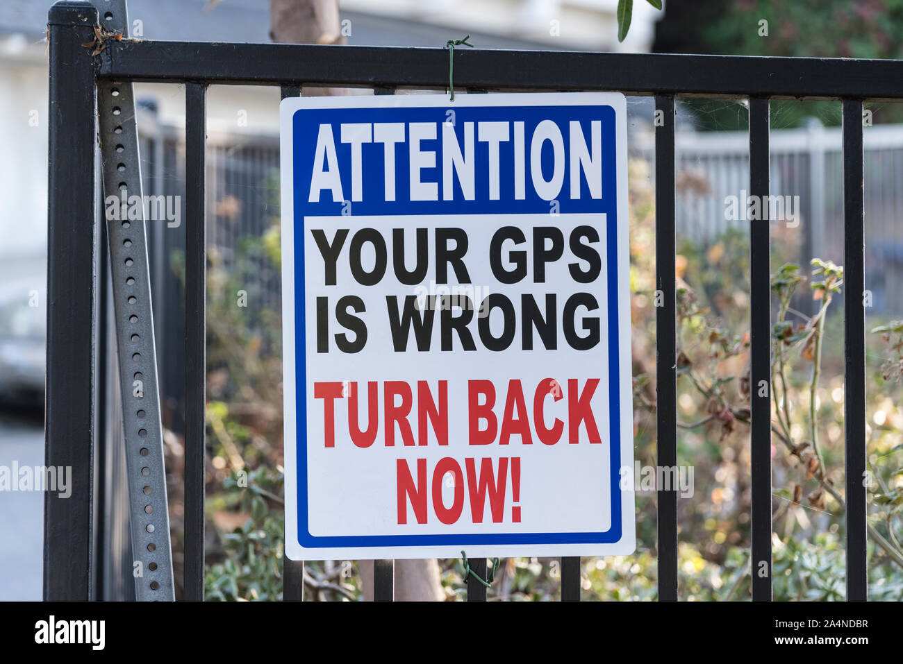 Attention your gps is wrong turn back now warning sign. Stock Photo