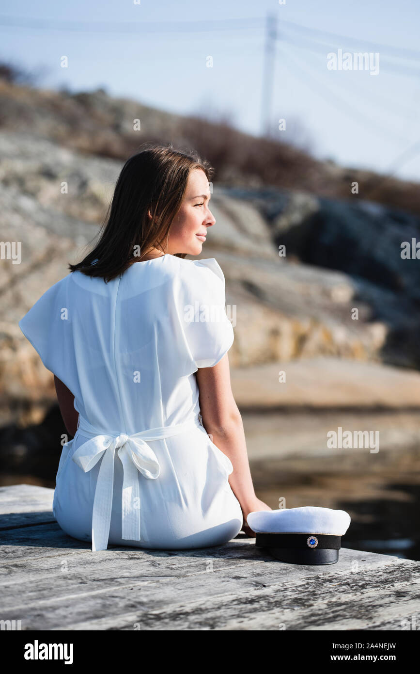 Woman in white dress sitting hi-res stock photography and images - Alamy