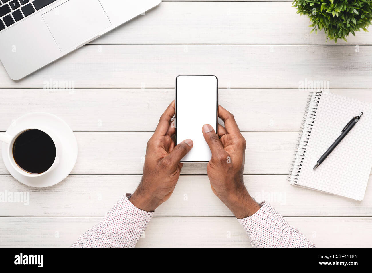Black man using modern smartphone with blank screen at workplace Stock ...