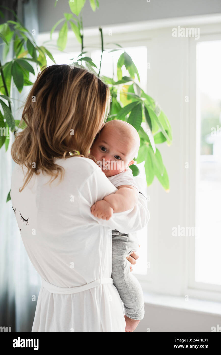 Woman carrying baby boy Stock Photo Alamy