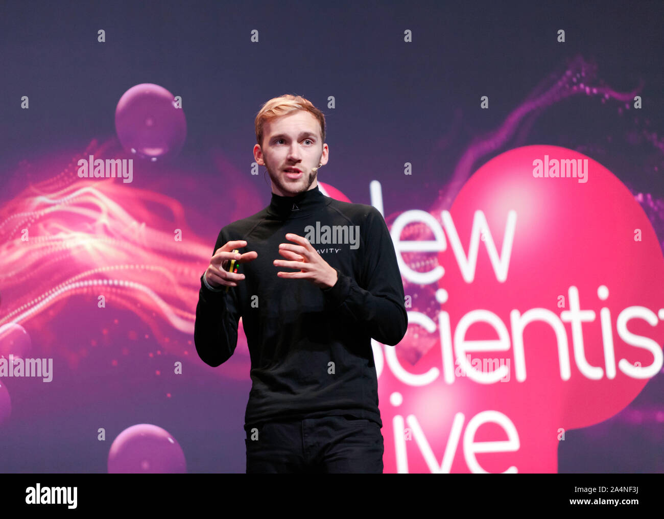 Sam Rogers Jet-suit designer and pilot, describing what its like to be a real-life Iron Man, on the Main Stage at New Scientist Live 2019 Stock Photo