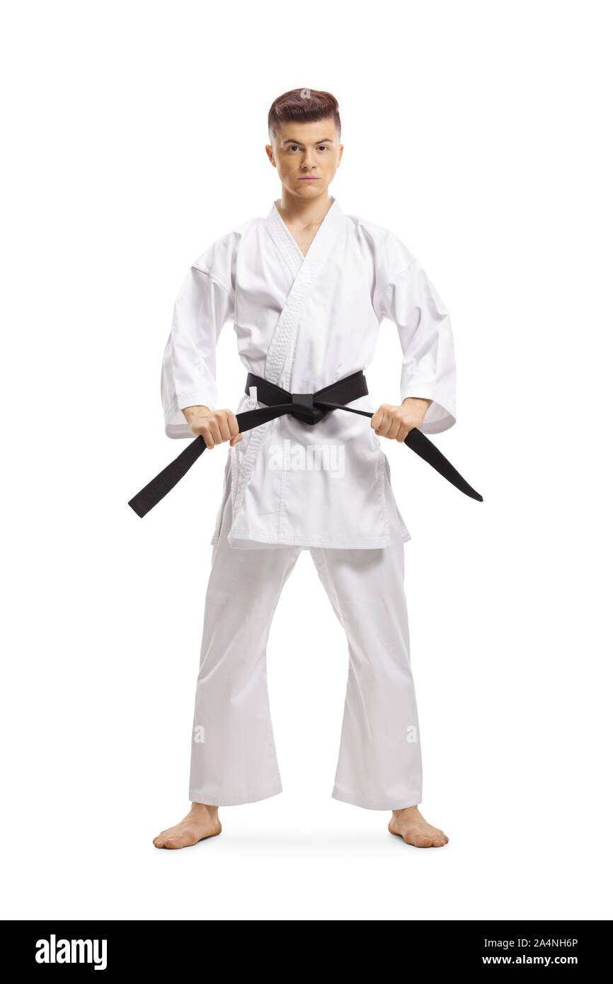 Full length portrait of a teenage boy in karate kimono holding his black belt isolated on white background Stock Photo
