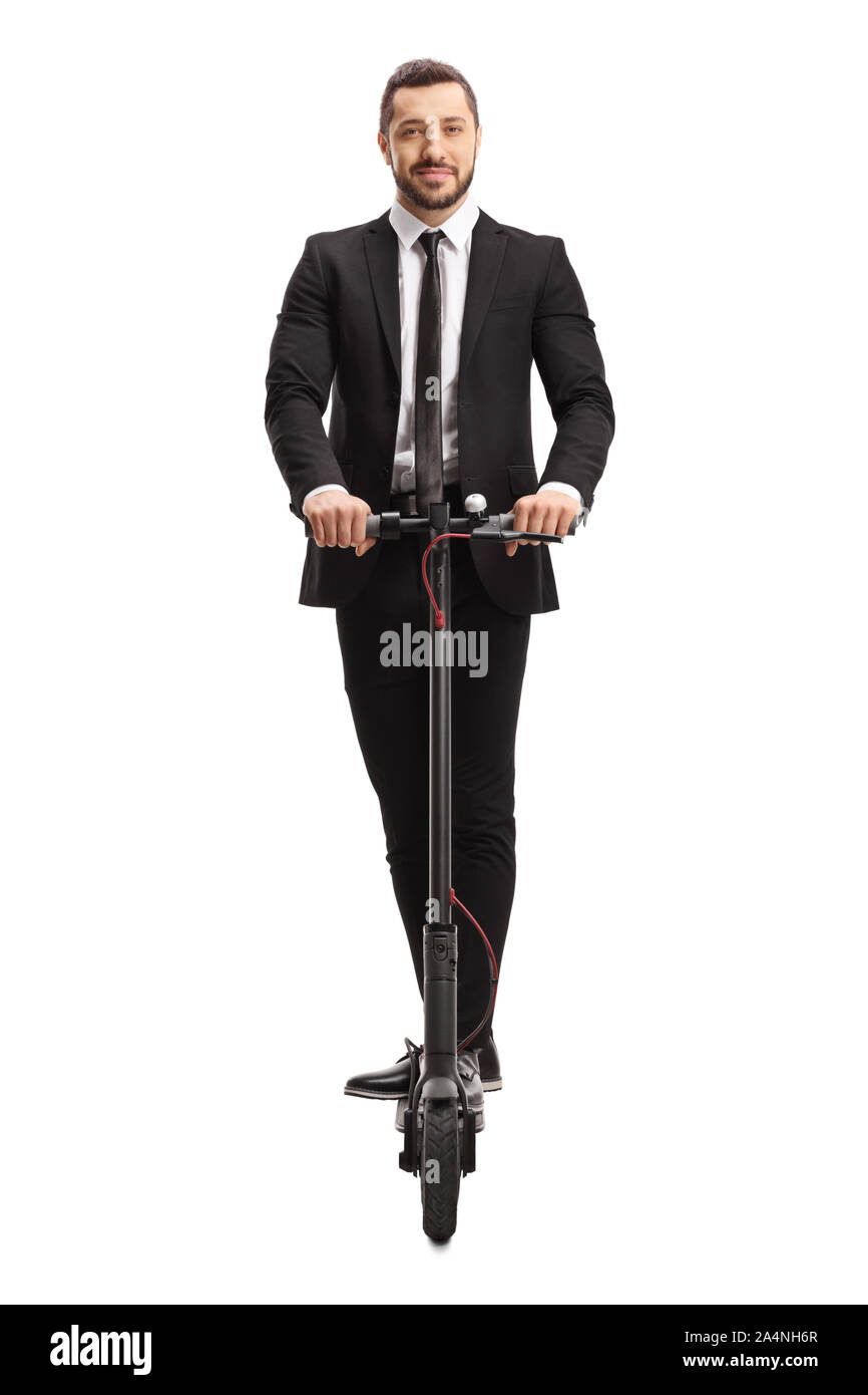 Full length portrait of a man in a suit riding an electric scooter