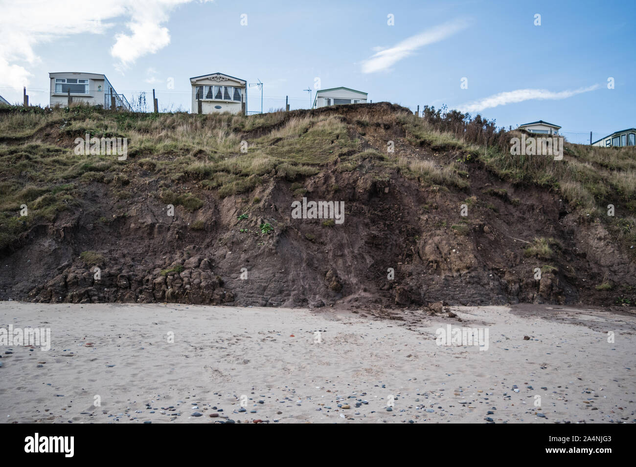 Effects of coastal erosion in Hornsea, in the East Riding of Yorkshire, showing holiday caravans close to areas of landslip from boulder clay. Stock Photo
