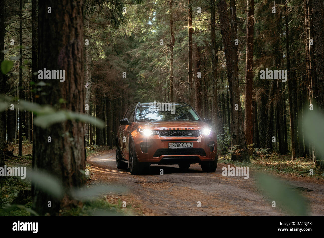 Minsk, Belarus - September 24, 2019: Land Rover Discovery Sport on country road n autumn forest landscape. Stock Photo