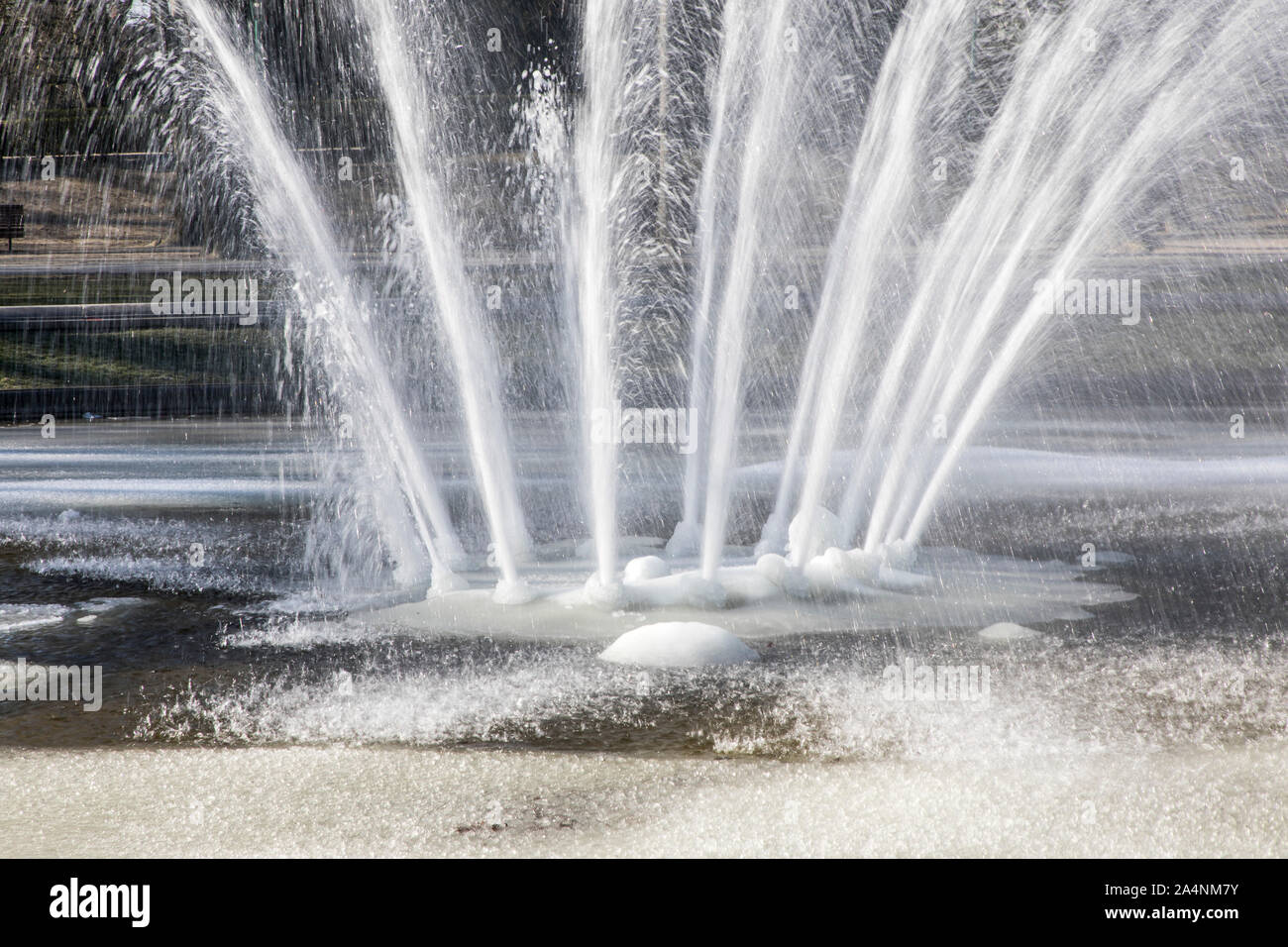 Water fountain, fountain, in winter, the water splashes, despite frost, minus temperatures, the water basin is frozen, Stock Photo