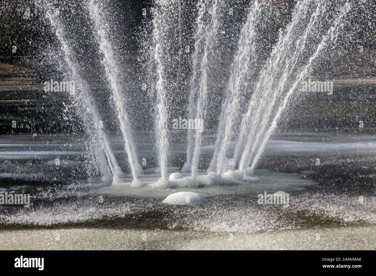 Water fountain, fountain, in winter, the water splashes, despite frost, minus temperatures, the water basin is frozen, Stock Photo