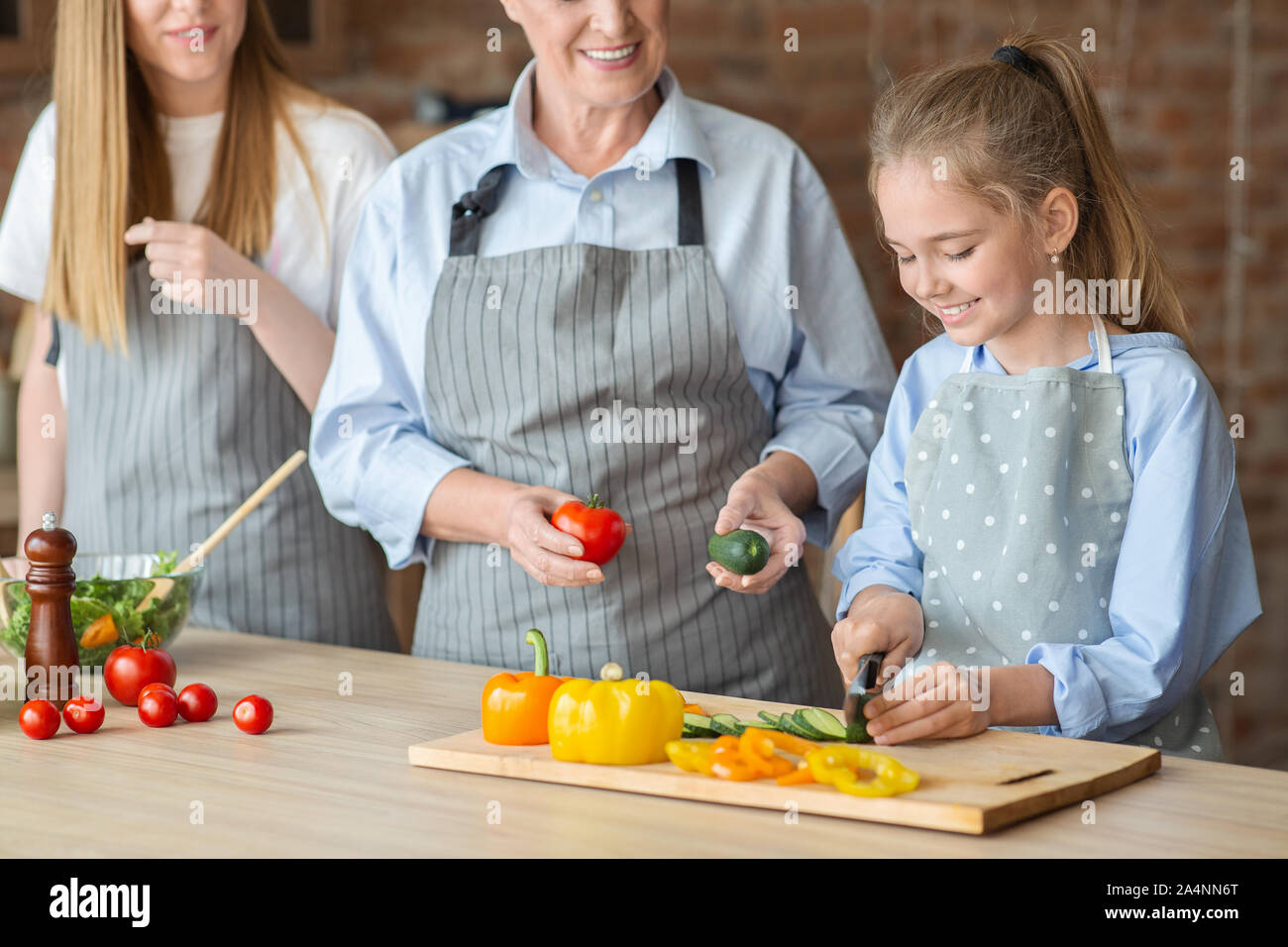 Adorable girl learning how to cut vegetables Stock Photo Alamy
