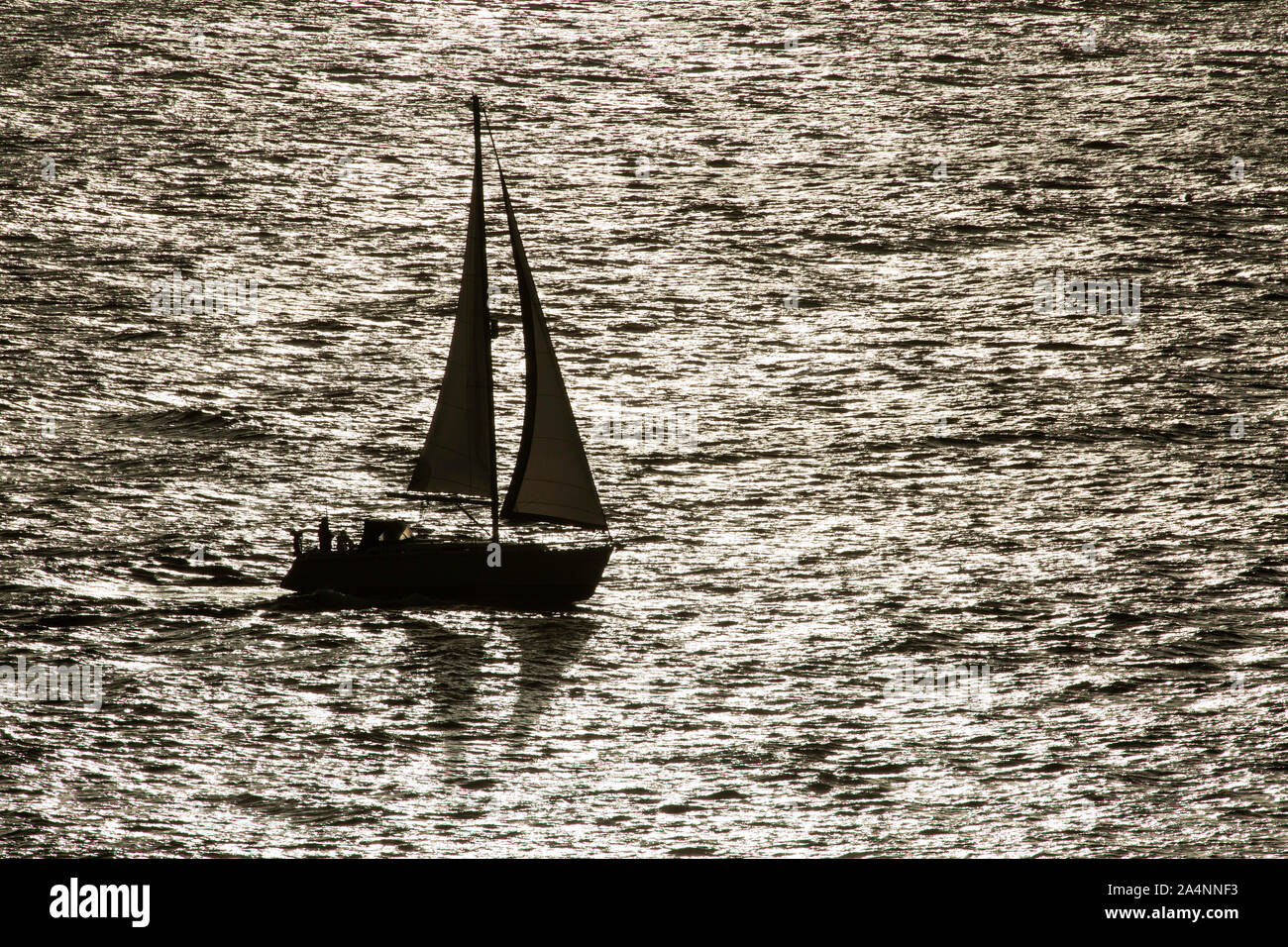 Yacht sailing off the coast, Dorset, UK Stock Photo Alamy