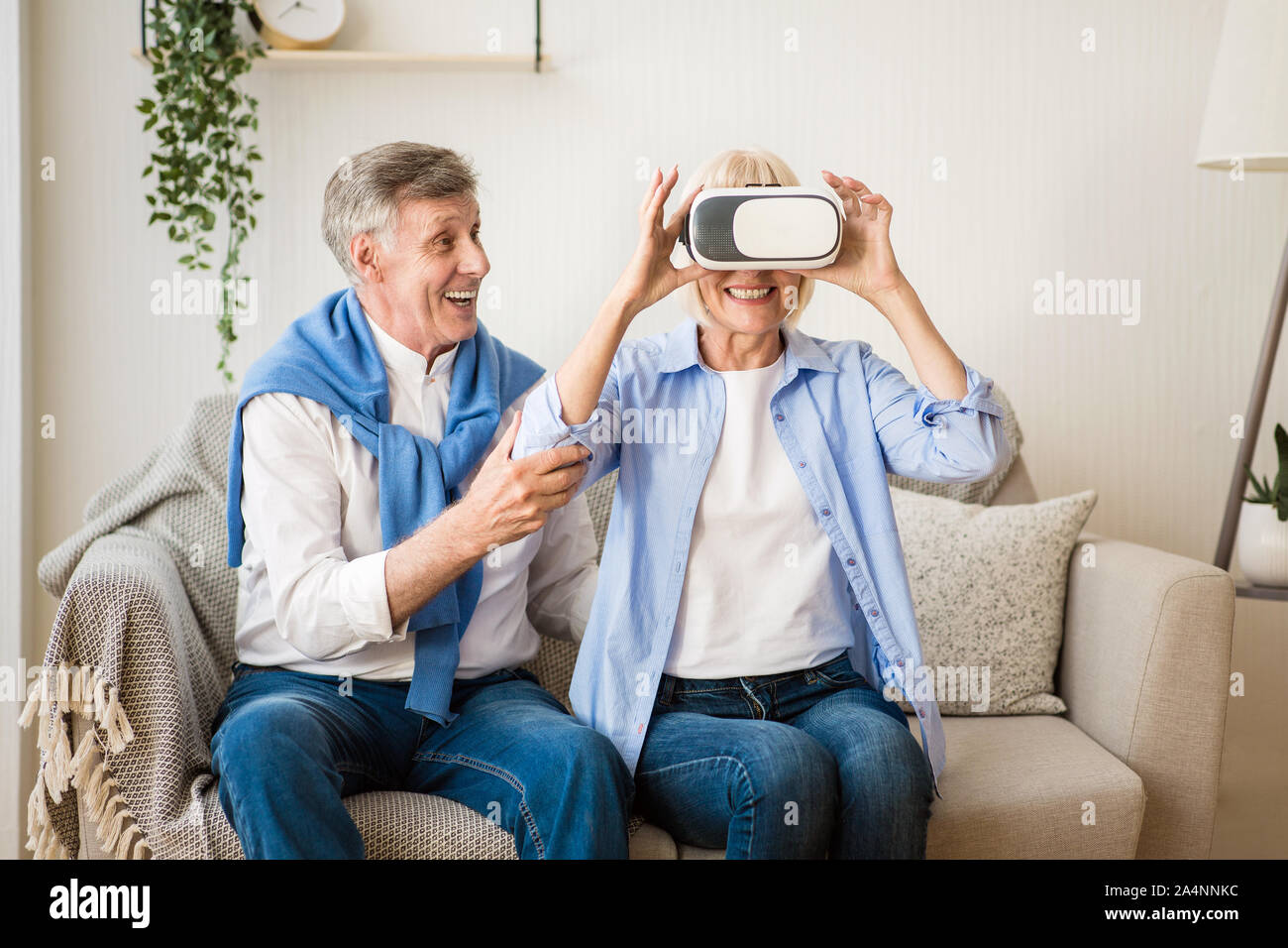 Modern technologies. Elder woman testing VR glasses Stock Photo